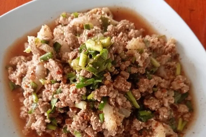 Close-up of a spicy Thai minced meat salad dish, possibly larb.